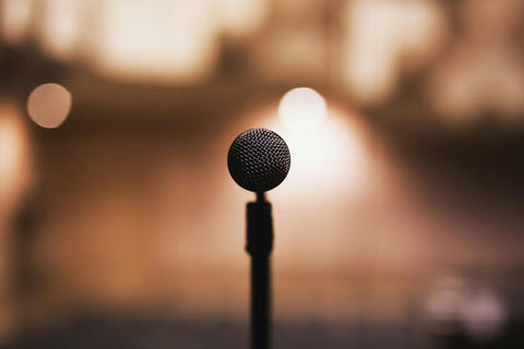 A Microphone in sharp focus, with a blurred, warm-toned background