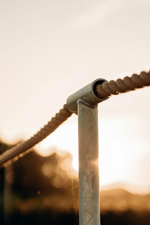 Metal pipe corner joint with a thick rope or cable running through it